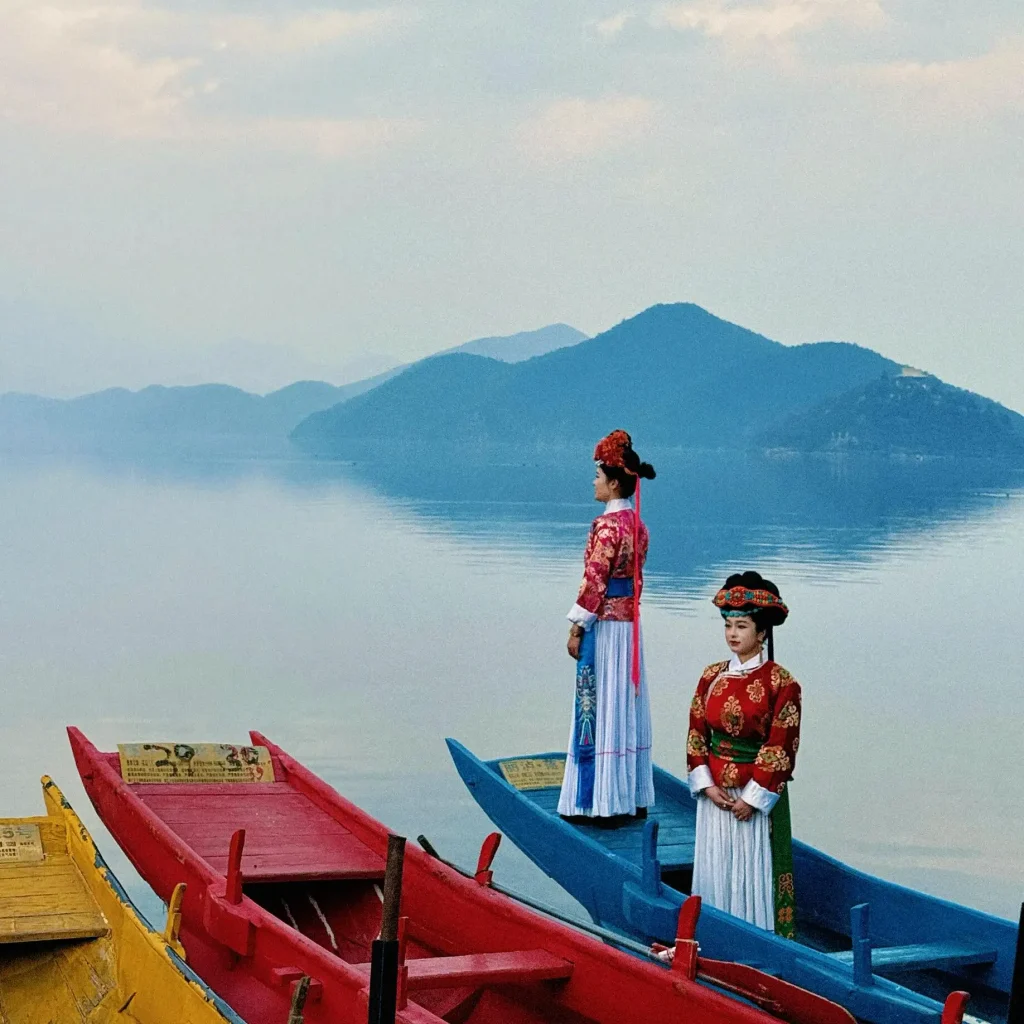 Mosuo people rowing boats on Lugu Lake