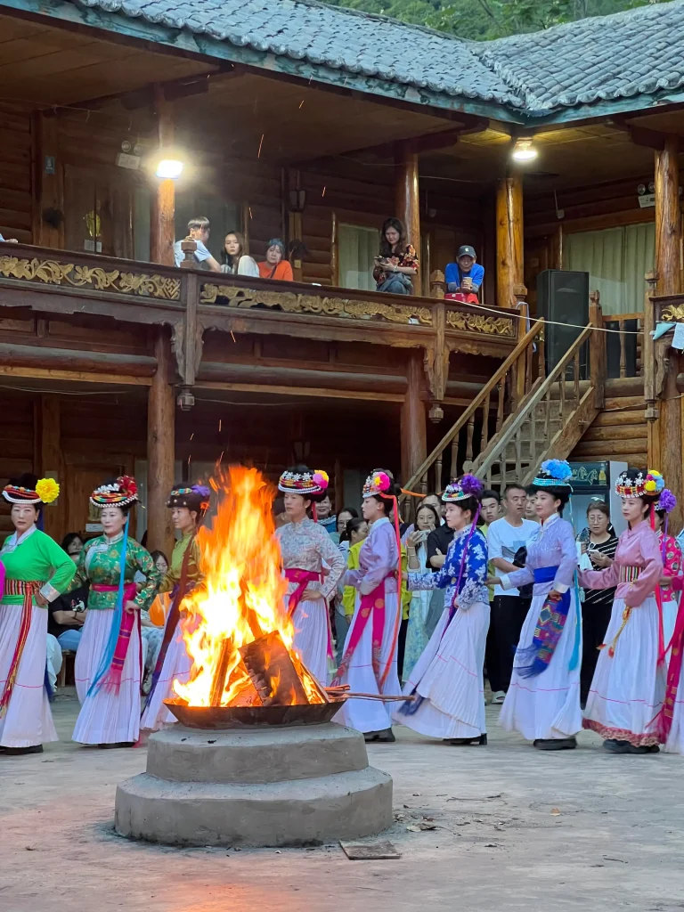 Mosuo bonfire gathering — young men and women performing the traditional Jiazuo dance