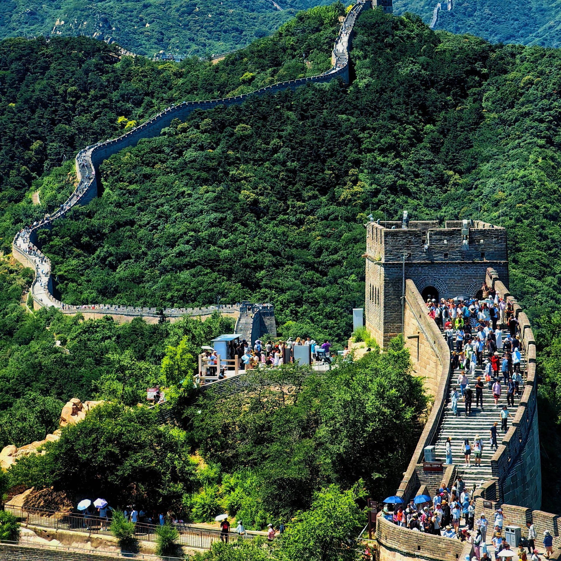 Tourists walking along a restored section of the Great Wall